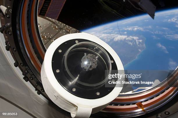 a moon rock floats aboard the international space station. - iss window stock pictures, royalty-free photos & images