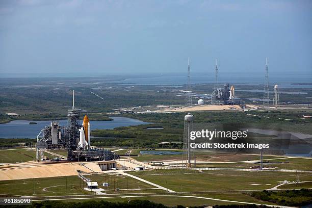 space shuttle atlantis on launch pad 39a is accompanied by space shuttle endeavour on launch pad 39b - spaceport stock pictures, royalty-free photos & images