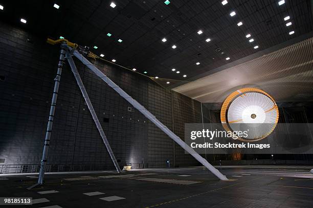a parachute undergoes flight-qualification testing inside a wind tunnel. - soufflerie photos et images de collection