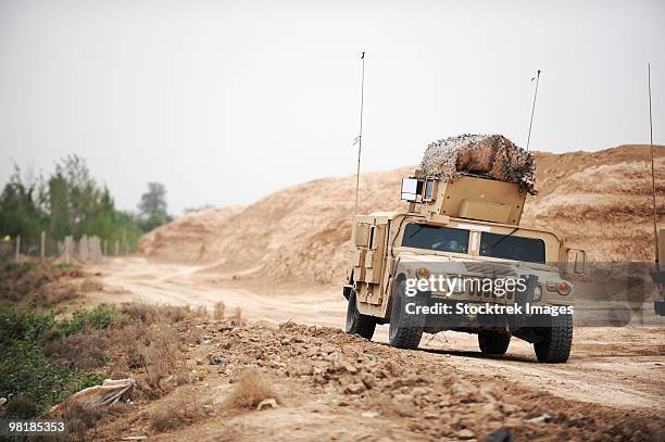 a humvee conducts security during a patrol in the iraqi village of bakr. - military vehicle bildbanksfoton och bilder