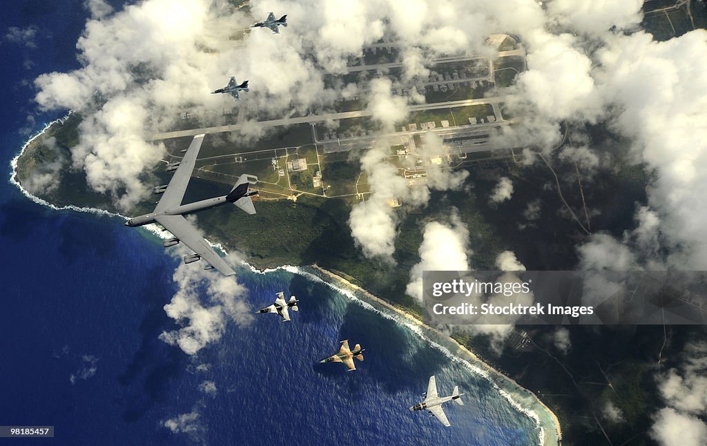 A B-52 Stratofortress leads a formation of aircraft over Guam.