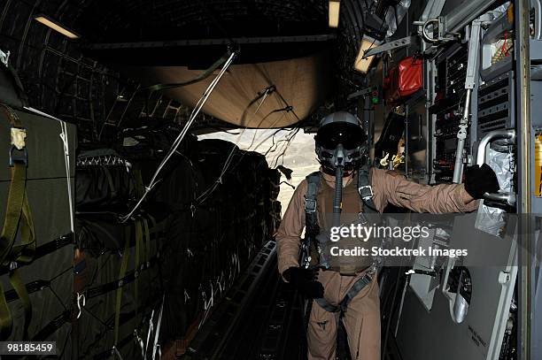 container delivery system bundles exit a c-17 globemaster during an airdrop mission. - military crate stock pictures, royalty-free photos & images