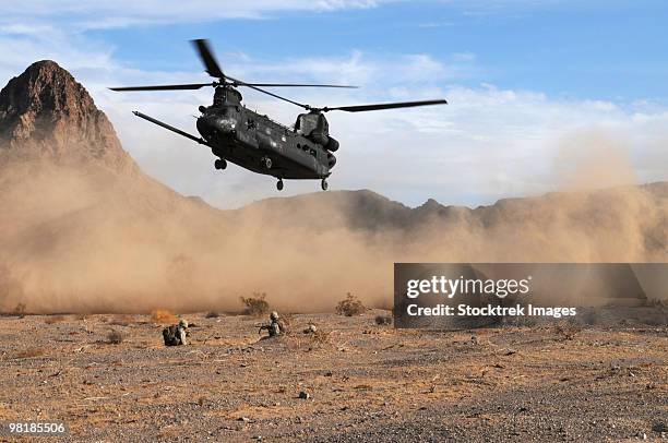 a ch-47 chinook prepares to land. - ch 47 chinook stock pictures, royalty-free photos & images