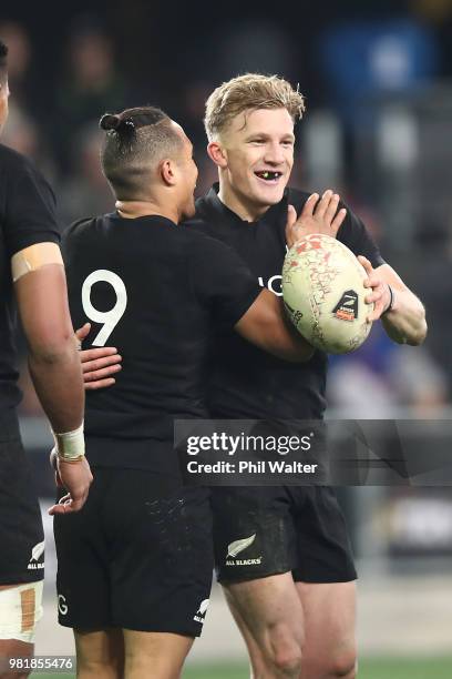 Damian McKenzie of the New Zealand All Blacks celebrates his try with Aaron Smith during the International Test match between the New Zealand All...