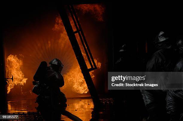 firefighters extinguish a simulated cargo fire at raf mildenhall, england. - fireman uk stock pictures, royalty-free photos & images