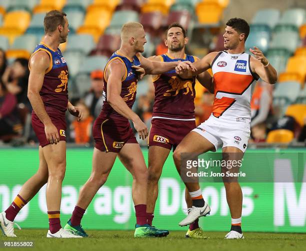 Nick Robertson of the Lions clashes with Jonathon Patton of the Giants during the round 14 AFL match between the Brisbane Lions and the Greater...