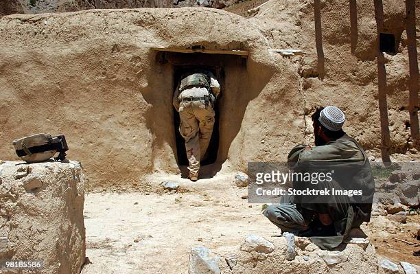 a soldier from the national guard searches the home of a suspected taliban member in afghanistan. - operation enduring freedom stock pictures, royalty-free photos & images