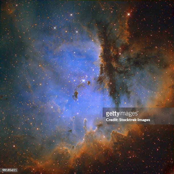 ngc 281, an h ii region in the constellation of cassiopeia and part of the perseus spiral arm. - pac man stock-fotos und bilder