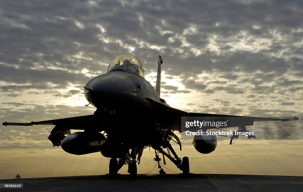 An F-16 Fighting Falcon sits tethered to the hot cargo pad at Joint Base Balad, Iraq.