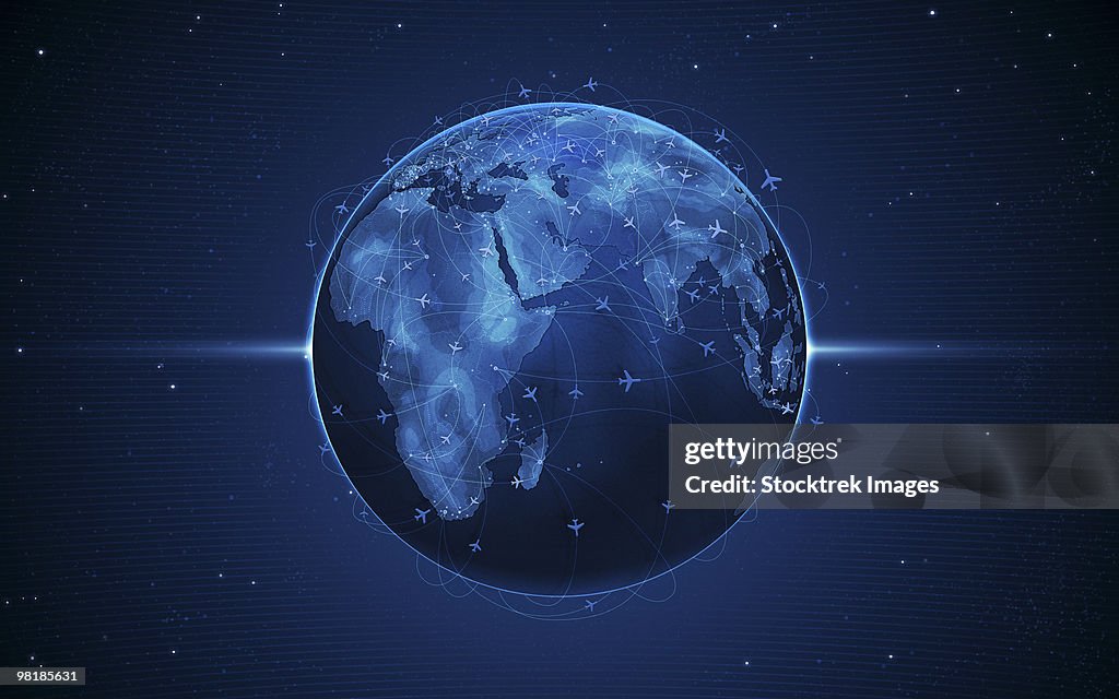Digitally generated image of airline flight paths around the globe.