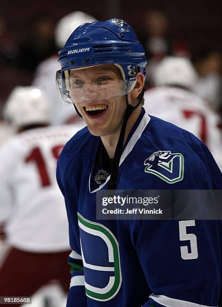 Christian Ehrhoff of the Vancouver Canucks laughs with a teammate during the game against the Phoenix Coyotes at General Motors Place on March 30,...