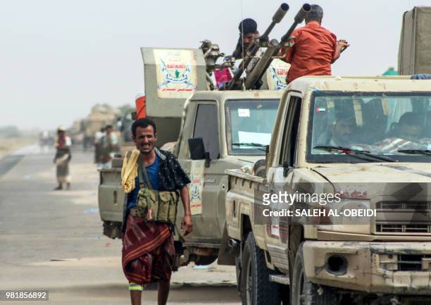 Yemeni fighters from the Amalqa Brigades, loyal to the Saudi-backed government, gather with armed pick-up trucks and armoured vehicles on the side of...