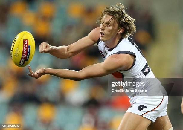 Lachie Whitfield of the Giants handpasses the ball during the round 14 AFL match between the Brisbane Lions and the Greater Western Sydney Giants at...