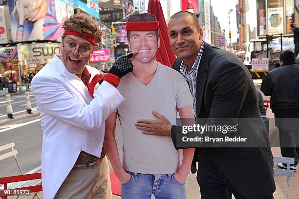 Singer Nick Mitchell and Nigel Barker perform while shooting Nicks new music video "Brit Slap" in Times Square on April 1, 2010 in New York City.