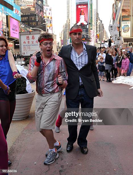 Singer Nick Mitchell and Nigel Barker perform while shooting Nicks new music video "Brit Slap" in Times Square on April 1, 2010 in New York City.