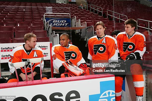Jeff Carter, Ray Emery, Kimmo Timonen and James van Riemsdyk of the Philadelphia Flyers prepare for the annual team photo on March 29, 2010 at the...