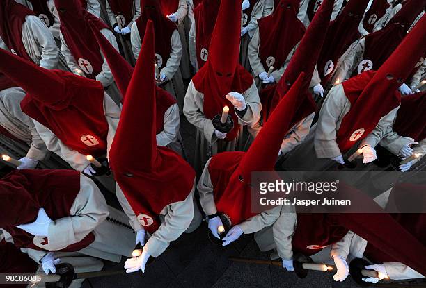 Penitents of the Cofradia del Silencio protect their candles from the wind during a Holy Week procession on March 31, 2010 in Zamora, Spain. Easter...