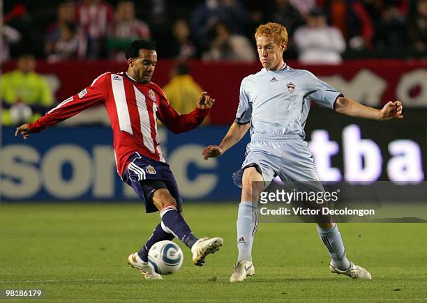 Jeff Larentowicz of the Colorado Rapids and Maykel Galindo of Chivas USA vie for the ball during their MLS match at the Home Depot Center on March...