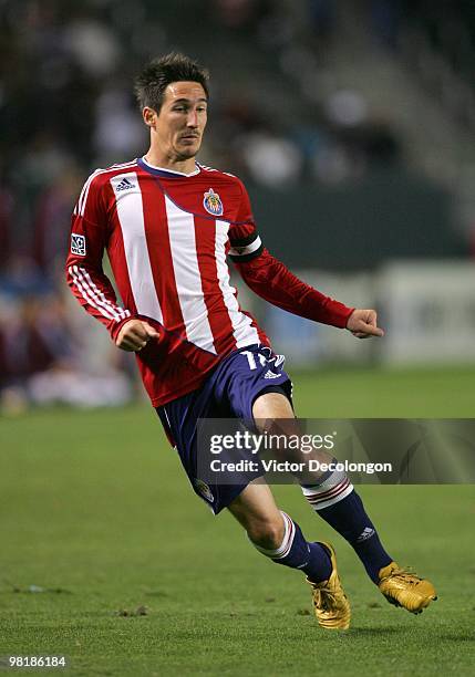 Sacha Kljestan#16 of Chivas USA pressures the Colorado Rapids defense during their MLS match at the Home Depot Center on March 26, 2010 in Carson,...