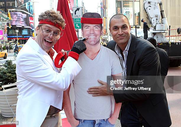 American Idol Contestant "Norman Gentle" aka Nick Mitchell and Nigel Barker shoot the "Brit Slap" music video in Times Square on April 1, 2010 in New...