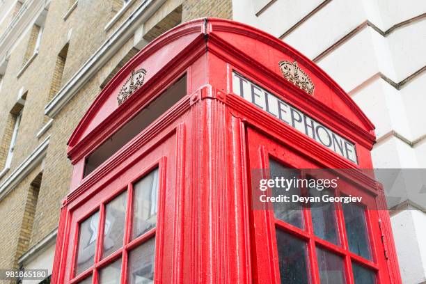 red phone cabine in london. - cabine stock pictures, royalty-free photos & images