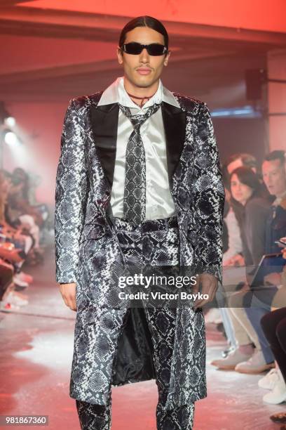 Model walks the runway during the WWWW SSS World Corp Menswear Spring/Summer 2019 show as part of Paris Fashion Week on June 22, 2018 in Paris,...