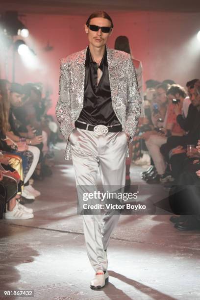 Model walks the runway during the WWWW SSS World Corp Menswear Spring/Summer 2019 show as part of Paris Fashion Week on June 22, 2018 in Paris,...