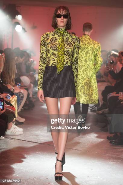 Model walks the runway during the WWWW SSS World Corp Menswear Spring/Summer 2019 show as part of Paris Fashion Week on June 22, 2018 in Paris,...