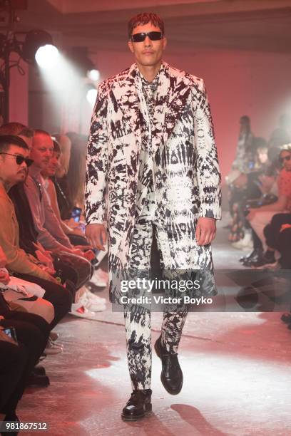 Model walks the runway during the WWWW SSS World Corp Menswear Spring/Summer 2019 show as part of Paris Fashion Week on June 22, 2018 in Paris,...