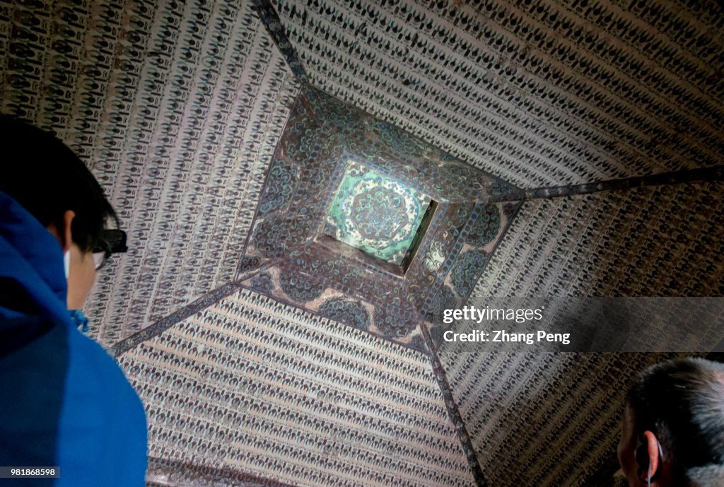 Ancient colorful murals on the cave roof. The Mogao Caves,...