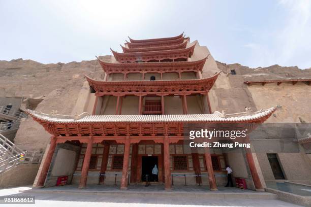 The highest building in Mogao cave, with 9 floor height, is the cave for the tallest Buddha statue. The Mogao Caves, also known as the Thousand...