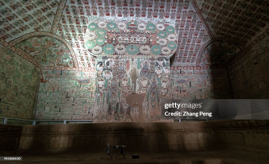 Ancient colorful murals on the cave wall, telling about...