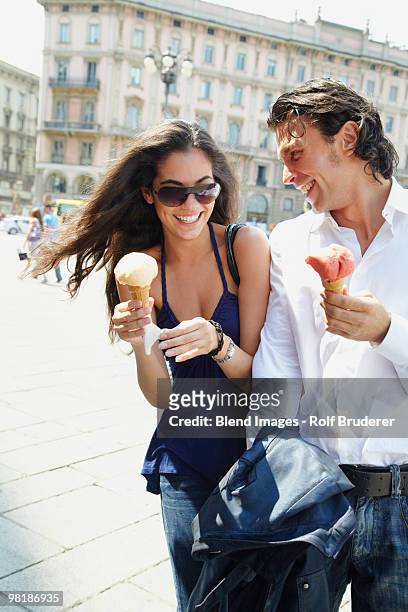 couple eating ice cream cones - milan food stock pictures, royalty-free photos & images