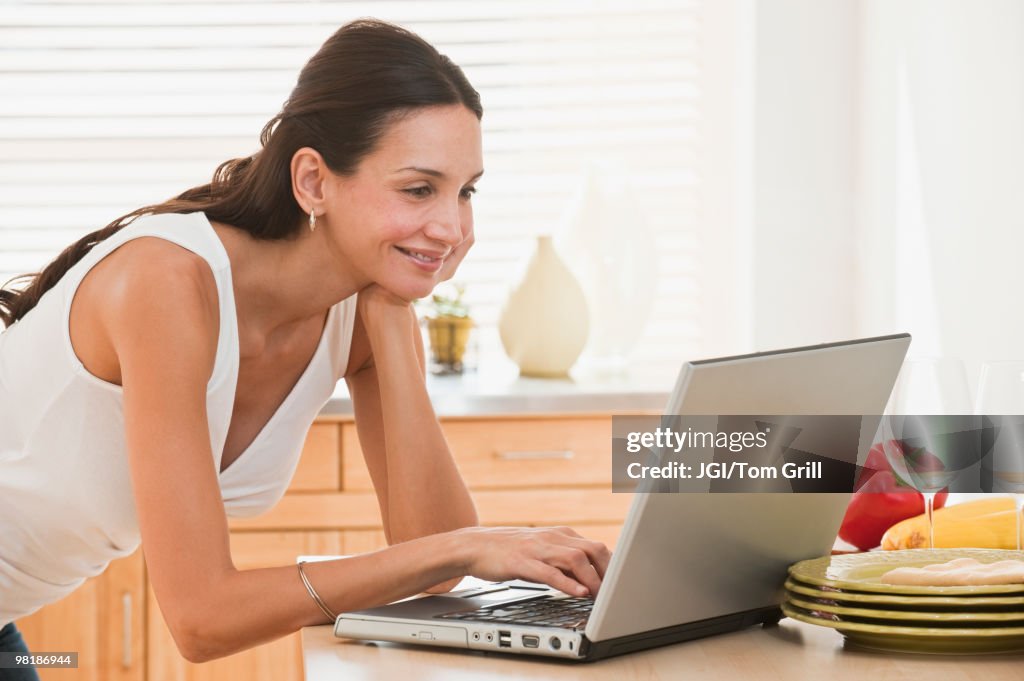 Hispanic woman using laptop
