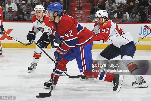 Dominic Moore of the Montreal Canadiens takes a shot in front of Michael Frolik of Florida Panthers during the NHL game on March 25, 2010 at the Bell...