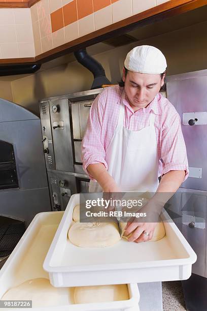 hispanic man cutting pizza dough - long branch, new jersey stock pictures, royalty-free photos & images