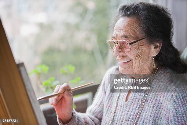 senior hispanic woman painting - arts express yourself 2009 stock pictures, royalty-free photos & images