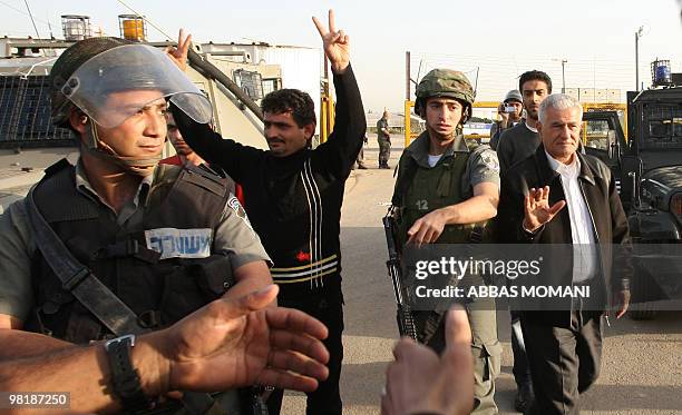 Israeli security forces stand guard as Palestinian Fatah leader Abbas Zaki waves to supporters and journalists following his release from prison on...