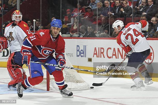 Bryan McCabe of Florida Panthers skates with the puck behind Scott Gomez of Montreal Canadiens during the NHL game on March 25, 2010 at the Bell...