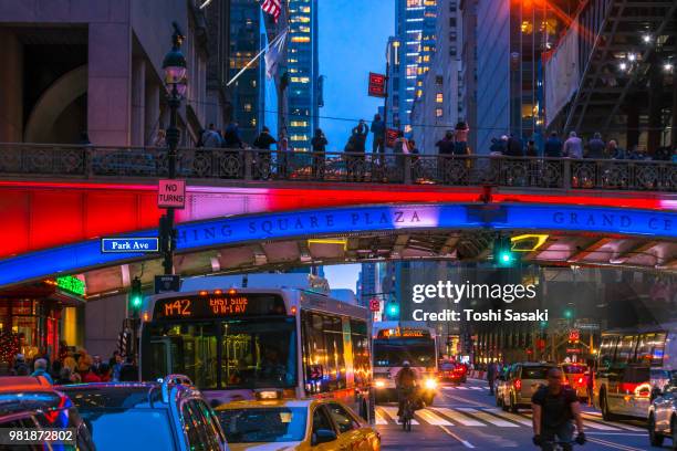 cars go through under the pershing square bridge and people cross the 42nd street after sunset for manhattanhenge new york u.s.a on 30 may 2018. - pershing square stock pictures, royalty-free photos & images