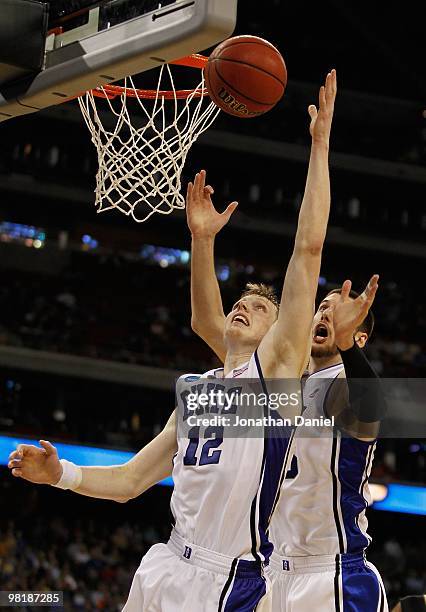 Kyle Singler of the Duke Blue Devils pulls down a rebound in front of teammate Brian Zoubek against the Purdue Boilermakers during the south regional...