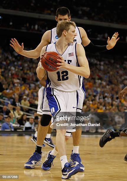 Kyle Singler of the Duke Blue Devils pulls down a rebound in front of teammate Brian Zoubek against the Purdue Boilermakers during the south regional...