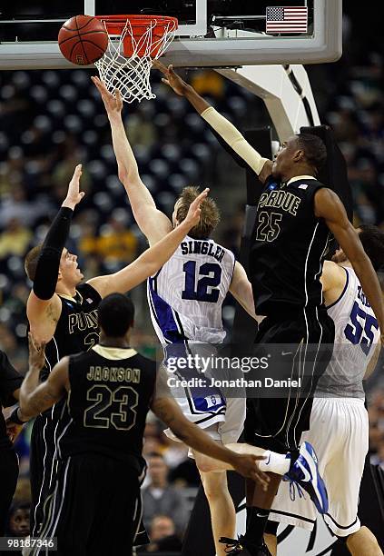 Kyle Singler of the Duke Blue Devils puts up a shot against Lewis Jackson, D.J. Byrd and JaJuan Johnson of the Purdue Boilermakers during the south...