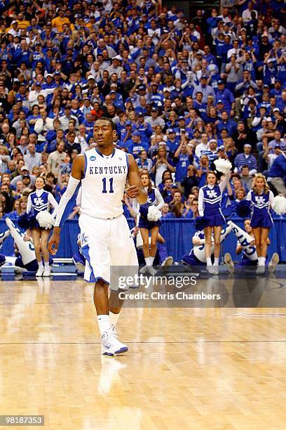 John Wall of the Kentucky Wildcats stands on court against the West Virginia Mountaineers during the east regional final of the 2010 NCAA men's...