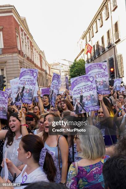 Demonstrators shout slogans and hold placard during a after a court ordered the release on bail of 'La Manada' in Madrid on 22nd June, 2018. The...