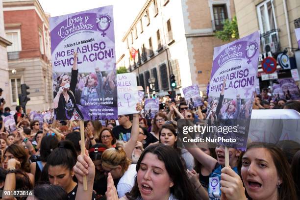 Demonstrators shout slogans and hold placard during a after a court ordered the release on bail of 'La Manada' in Madrid on 22nd June, 2018. The...