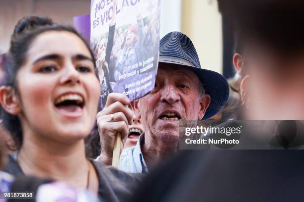 Demonstrators shout slogans and hold placard during a after a court ordered the release on bail of 'La Manada' in Madrid on 22nd June, 2018. The...