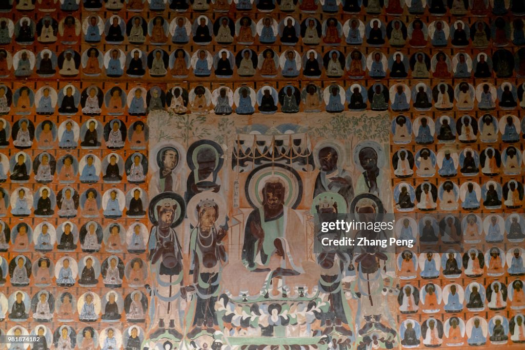 Ancient colorful murals on the cave wall, telling about...
