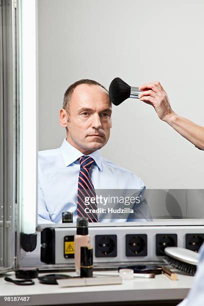 a mature man having make-up done - man backstage stock pictures, royalty-free photos & images