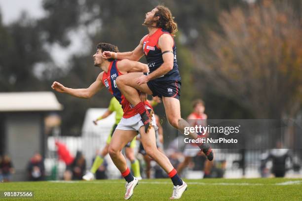 Jack Hutchins of the Casey Demons jumps over Harrison Nolan of Coburg during the VFL round 12 game between Casey and Coburg at Casey Fields in...